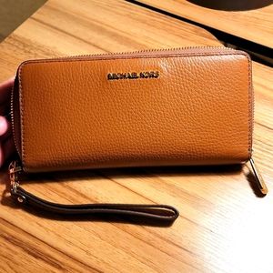 Michael Kors leather ziparound wallet with wristlet attachment.